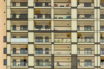 Glass balcony exterior. Condominium neighborhood. Modern block building.