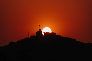 View of the sunset at the temple above the mountains at Wankaner, Gujarat, India