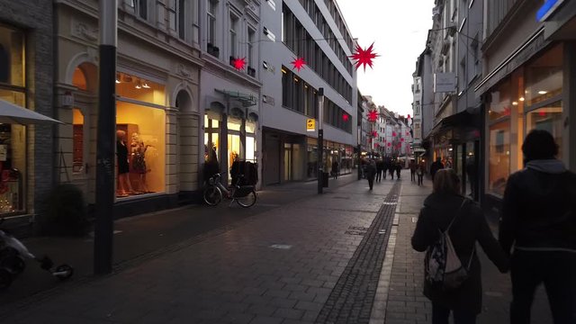 Bonn Germany, 30 November 2019: A walk down a street decorated for Christmas with lots of people walking there