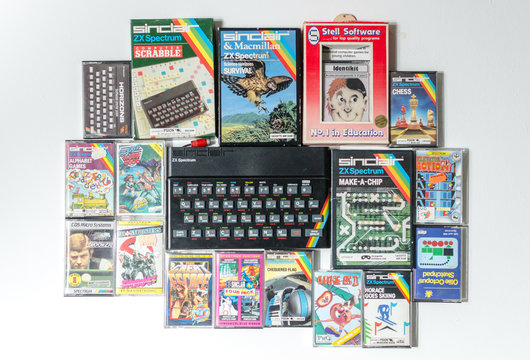 london, eng;and, 05/05/2019 A retro vintage nostalgic sinclair zx spectrum 48k 1980s computer console with games and retro joystick controllers on a white background.