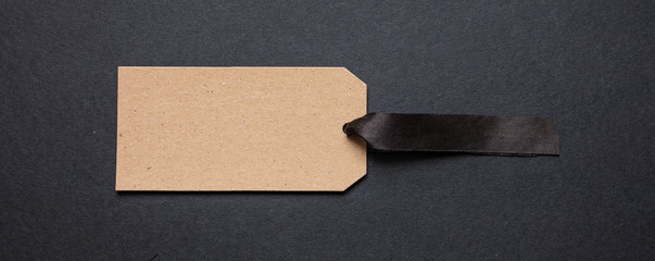 Beige recycled price card against black background