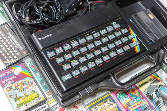 london, eng;and, 05/05/2019 A retro vintage nostalgic sinclair zx spectrum 48k 1980s computer console with games and retro joystick controllers on a white background.