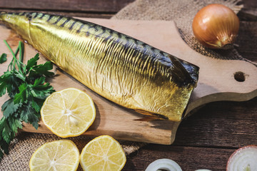 smoked mackerel carcass on a wooden background.