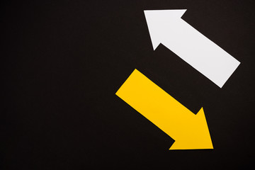 top view of directional white and yellow arrows isolated on black