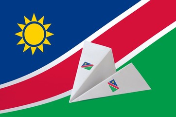 Namibia flag depicted on paper origami airplane. Handmade arts concept