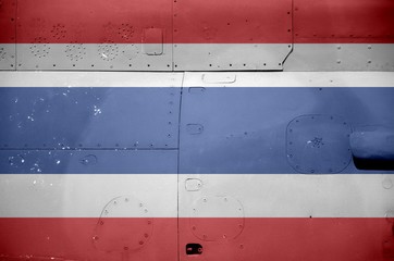 Thailand flag depicted on side part of military armored helicopter closeup. Army forces aircraft...