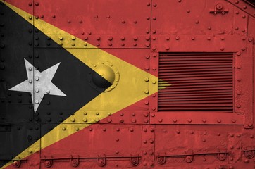Timor Leste flag depicted on side part of military armored tank closeup. Army forces conceptual...