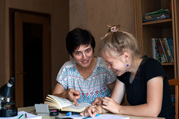 Teen girl with   tutor   learning   lessons.