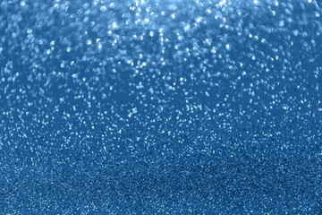 Obraz premium Blurred glitter blue background for holiday and any project. Shallow depth of field. Horizontal