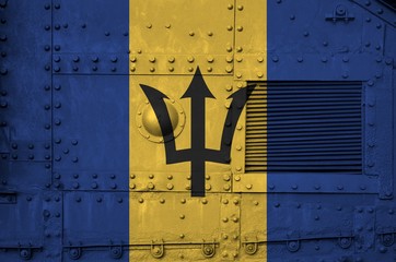 Barbados flag depicted on side part of military armored tank closeup. Army forces conceptual...