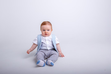 baby boy sitting on a white background