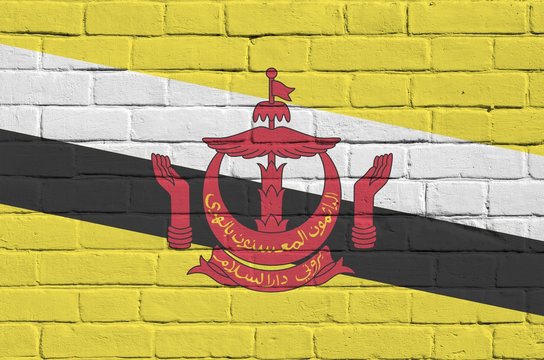 Brunei Darussalam flag depicted in paint colors on old brick wall. Textured banner on big brick wall masonry background