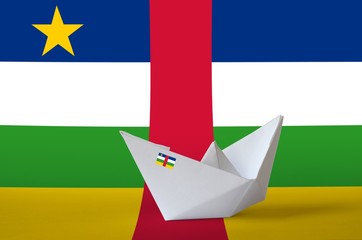 Central African Republic flag depicted on paper origami ship closeup. Handmade arts concept