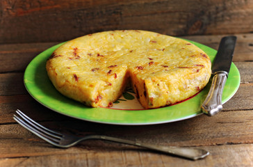 Juicy and tasty Spanish omelette with sausage and silverware