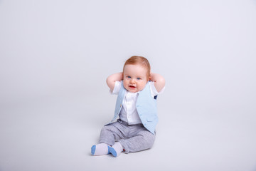 baby boy sitting on a white background