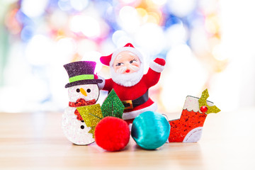 Santa with Snowman and red sock over blurred bright colorful bokeh background, Happy Christmas concept