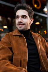 Portrait of young casual man happily looking away outdoor