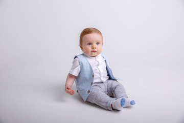 baby boy sitting on a white background