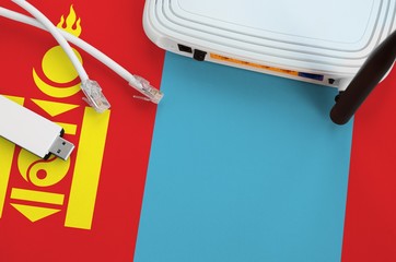 Mongolia flag depicted on table with internet rj45 cable, wireless usb wifi adapter and router....