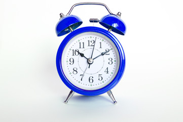 blue round analog alarm clock on white background. time 10:10. classic blue color 2020