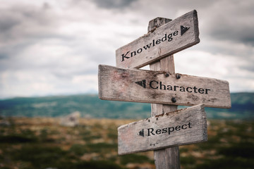 Knowledge, character and respect  text on wooden rustic signpost outdoors in nature/mountain scenery. Empowerment, education, study and work ethics concept.