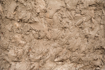 Abstract background. Rough texture, beige preliminary plaster on the wall with irregularities. Structure, background.