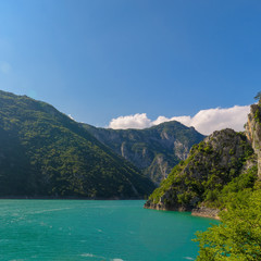 Fototapeta premium Aerial photo of Piva Lake in Montenegro. Road above Piva Lake (Pivsko Jezero). Montenegro, Pluzine, Lake of Piva, Mratinje Dam.