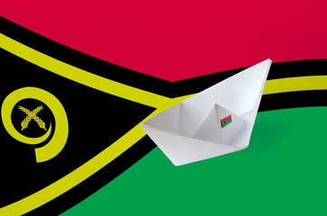 Vanuatu flag depicted on paper origami ship closeup. Handmade arts concept
