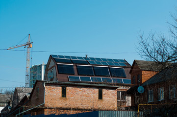  Solar panel system on house roof, sunny blue sky background.Blue solar panels.	
