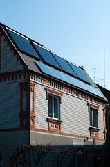  Solar panel system on house roof, sunny blue sky background.Blue solar panels.	