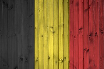 Belgium flag depicted in bright paint colors on old wooden wall. Textured banner on rough background