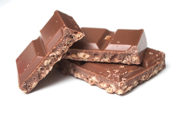 closeup of milk puffed rice chocolate blocks on white background