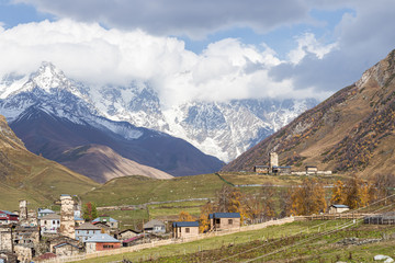 Ushguli  village on a background of mountains and snow-capped peaks in Svaneti in the mountainous part of Georgia