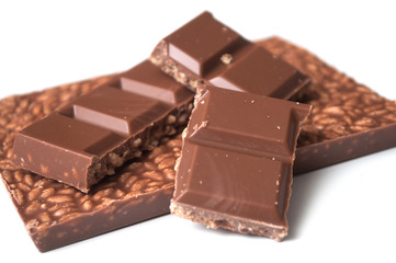 closeup of milk puffed rice chocolate blocks on white background