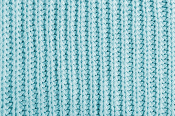 Blue texture of a large knit sweater. Knitted scarf background, winter cozy textile background
