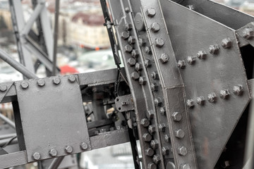 Close-up grey painted steel iron construcion frame beam of old giant ferris wheel in Prater amusement park in Vienna. Industrial metal structure background