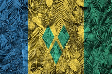 Saint Vincent and the Grenadines flag depicted on many leafs of monstera palm trees. Trendy...