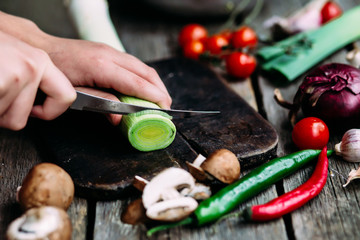 woman cutting vegetables in kitchen