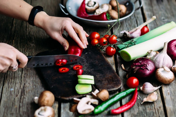 woman cutting vegetables in kitchen