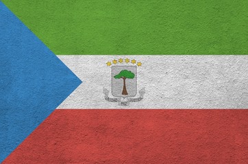Equatorial Guinea flag depicted in bright paint colors on old relief plastering wall. Textured...
