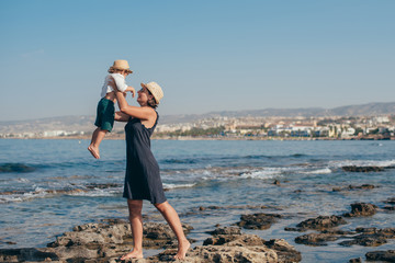 Mom with a little son on a trip near the sea.