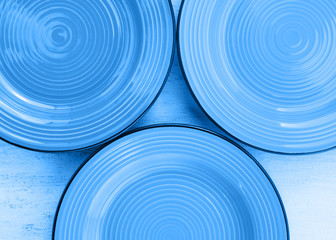 Classical blue ceramic dishes top view background. color of 2020
