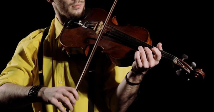 Man professional violinist playing on violin on black background, instrument closeup. Guy musician violist playing solo on alt. Elegant person performs classical composition on fiddlestick instrument.