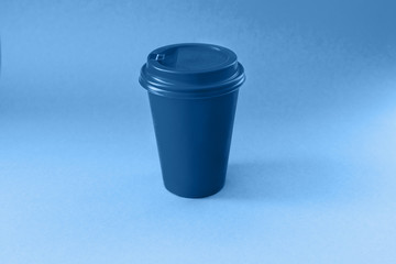 Paper blue glass on a blue background. Classic blue color 