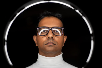 future technology, augmented reality and vision concept - indian man in glasses with white...