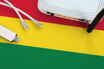 Bolivia flag depicted on table with internet rj45 cable, wireless usb wifi adapter and router....