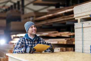 Young male worker in timber warehouse 