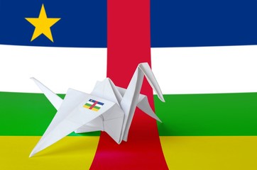 Central African Republic flag depicted on paper origami crane wing. Handmade arts concept