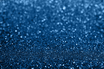Abstract composition. Blue glitter light background with beautiful bokeh. Color of the year 2020