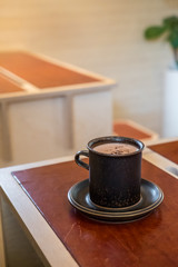 A cup of hot chocolate on the wooden table
